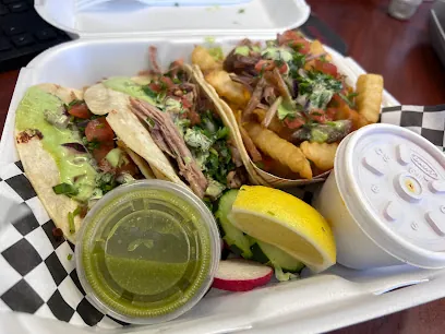 Takeout plate of tacos with salsa verde, lemon and fries from La Villa 805